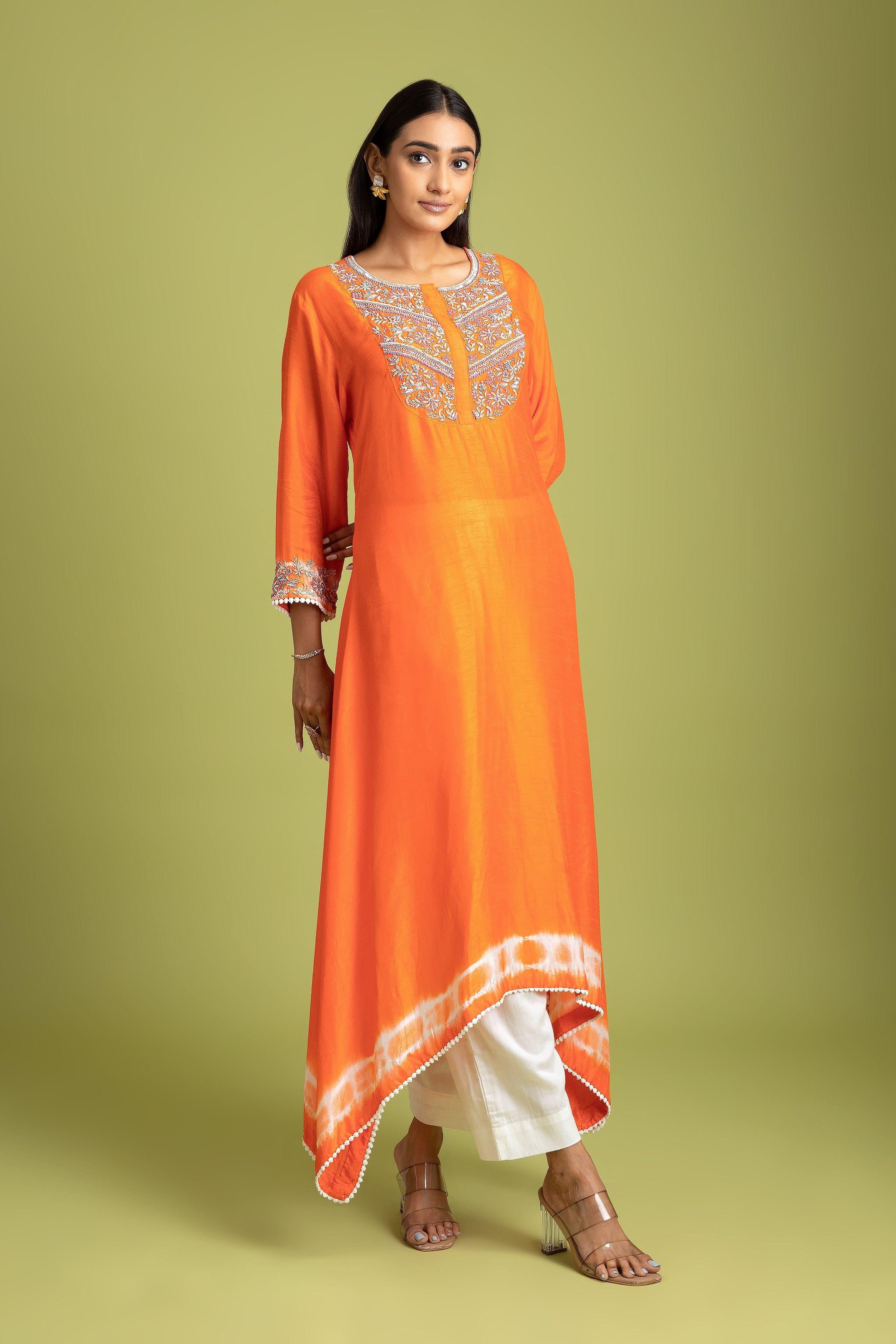 orange dress kurti This orange kurti features a beautiful blue section that adds a subtle  contrast, ideal for both office settings and temple visits. Designed for  comfort and style, it offers a blend of professionalism