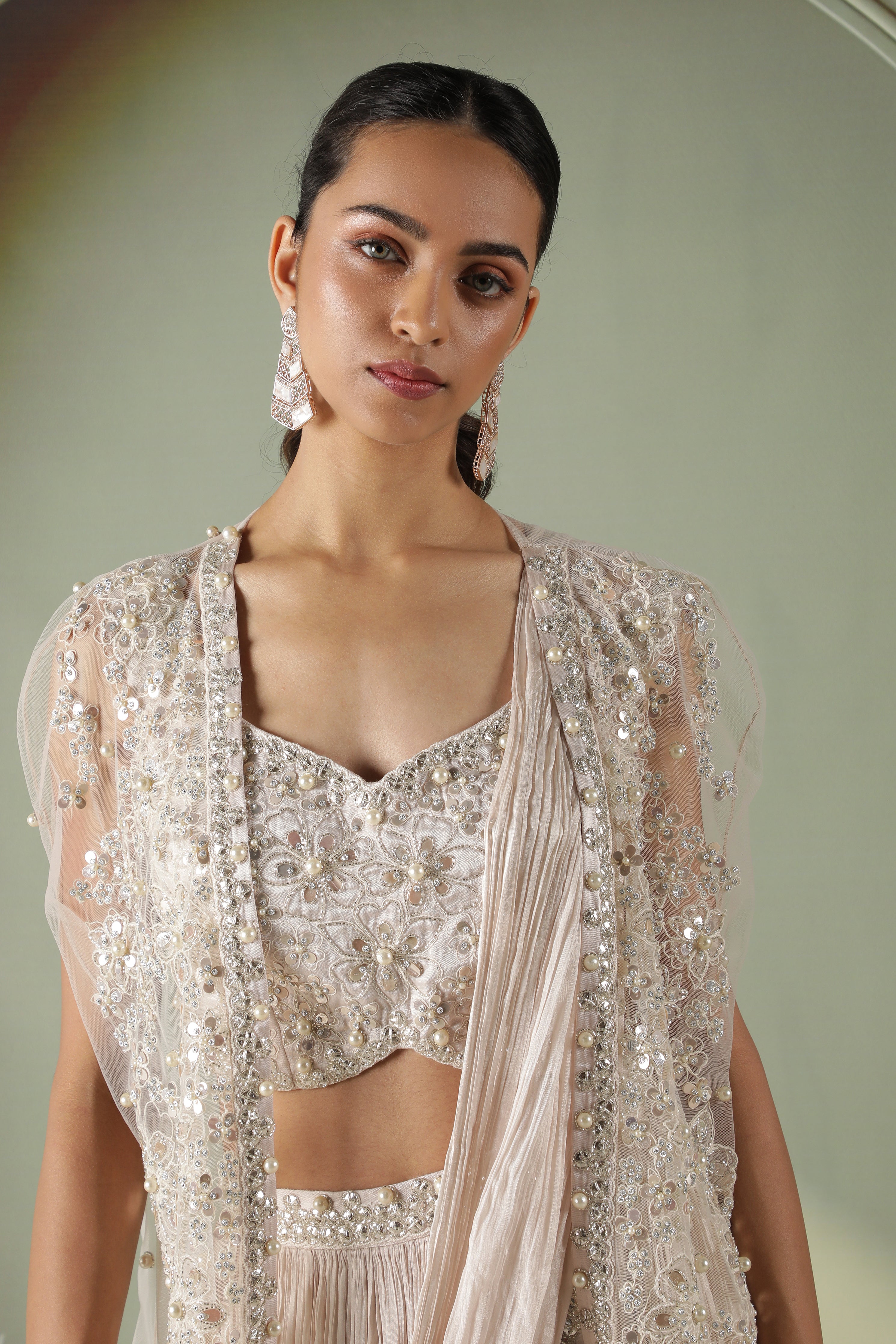Ivory Silk Lehenga with Draped Dupatta and Embellished Net Cape