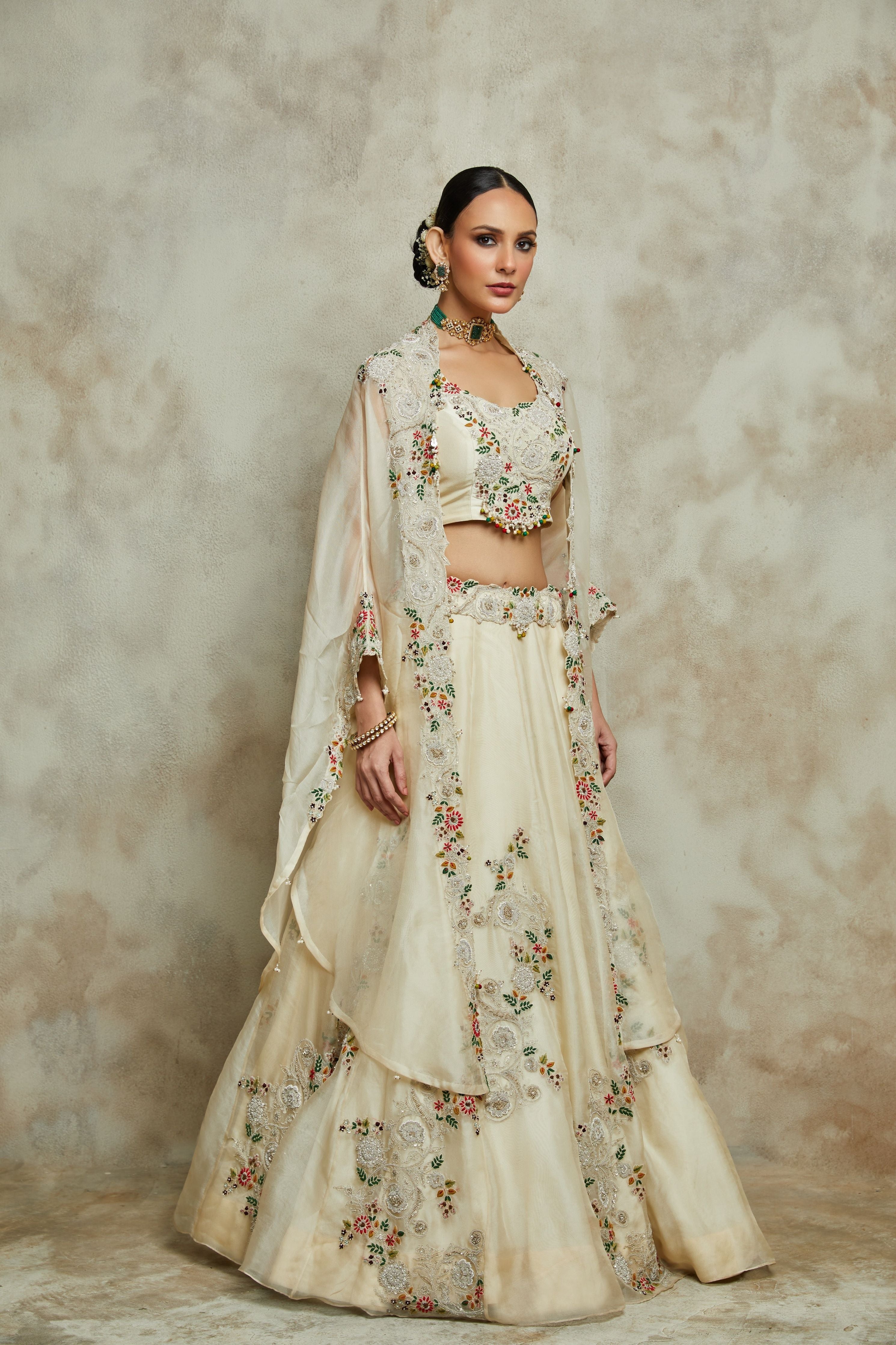 Ivory silk blouse with organza cape and lehenga  Mokshaa