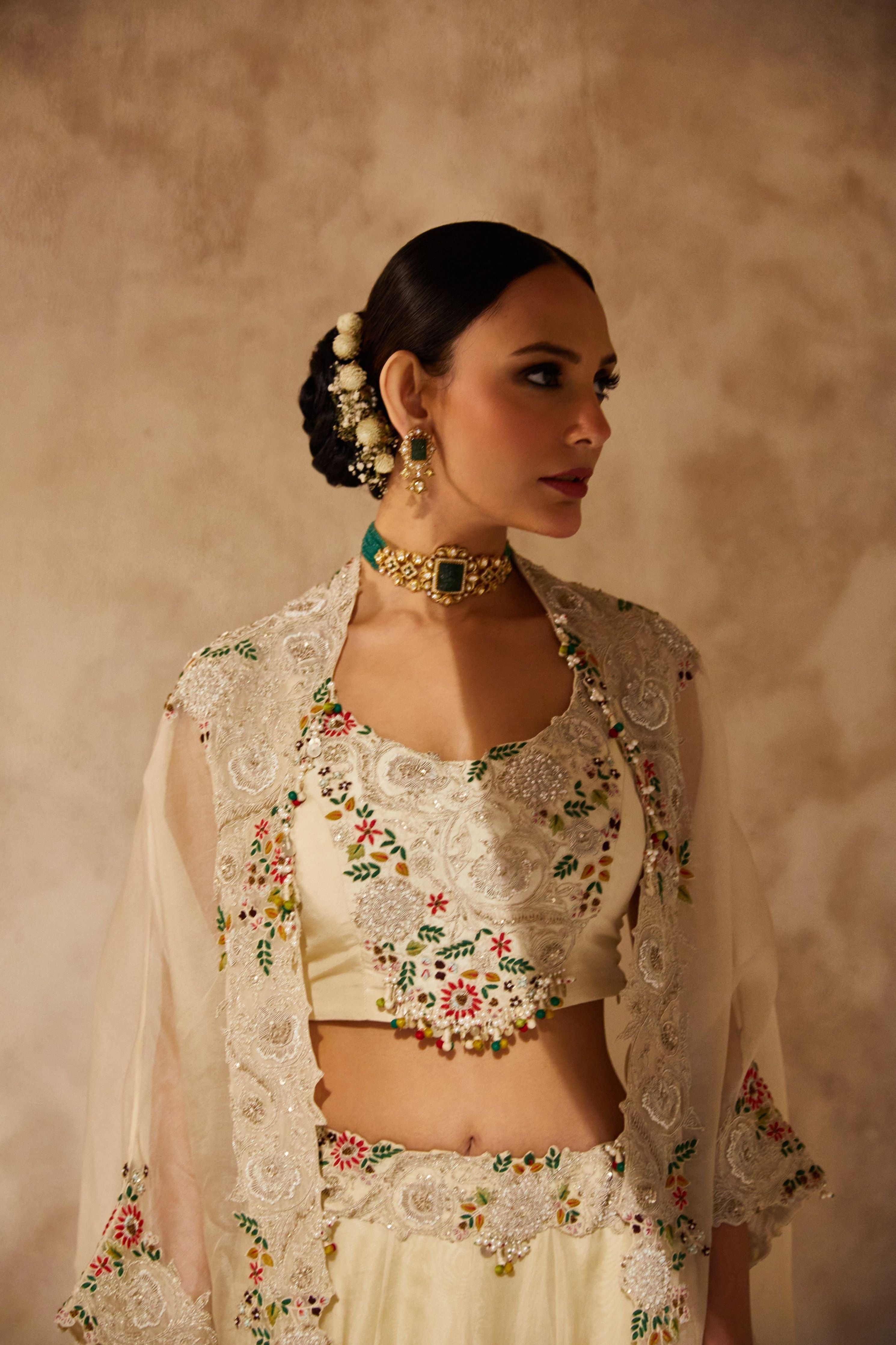 Ivory silk blouse with organza cape and lehenga  Mokshaa