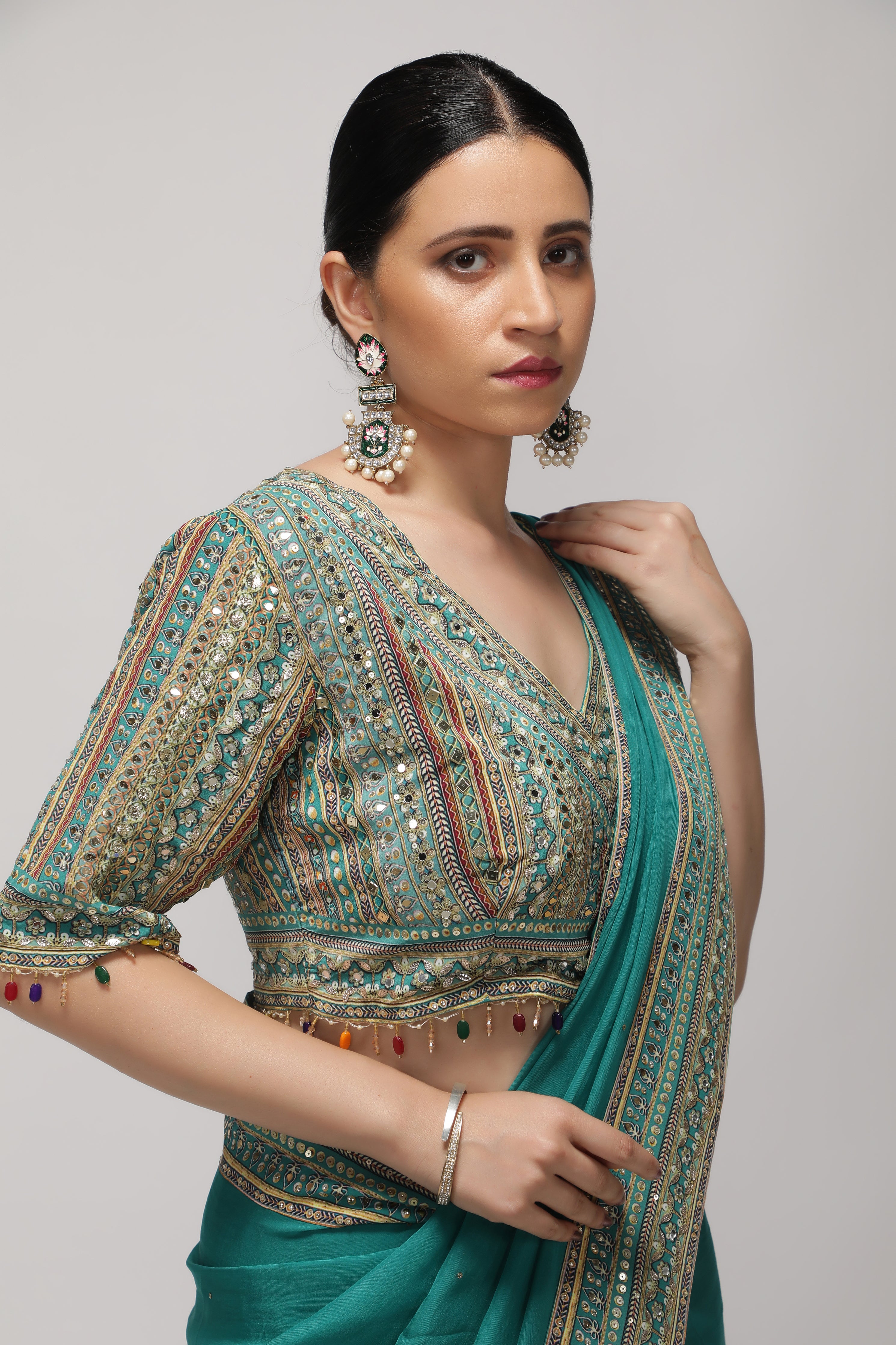 Teal Green Silk Organza Saree with Sequin Highlights & Mirror Work Border
