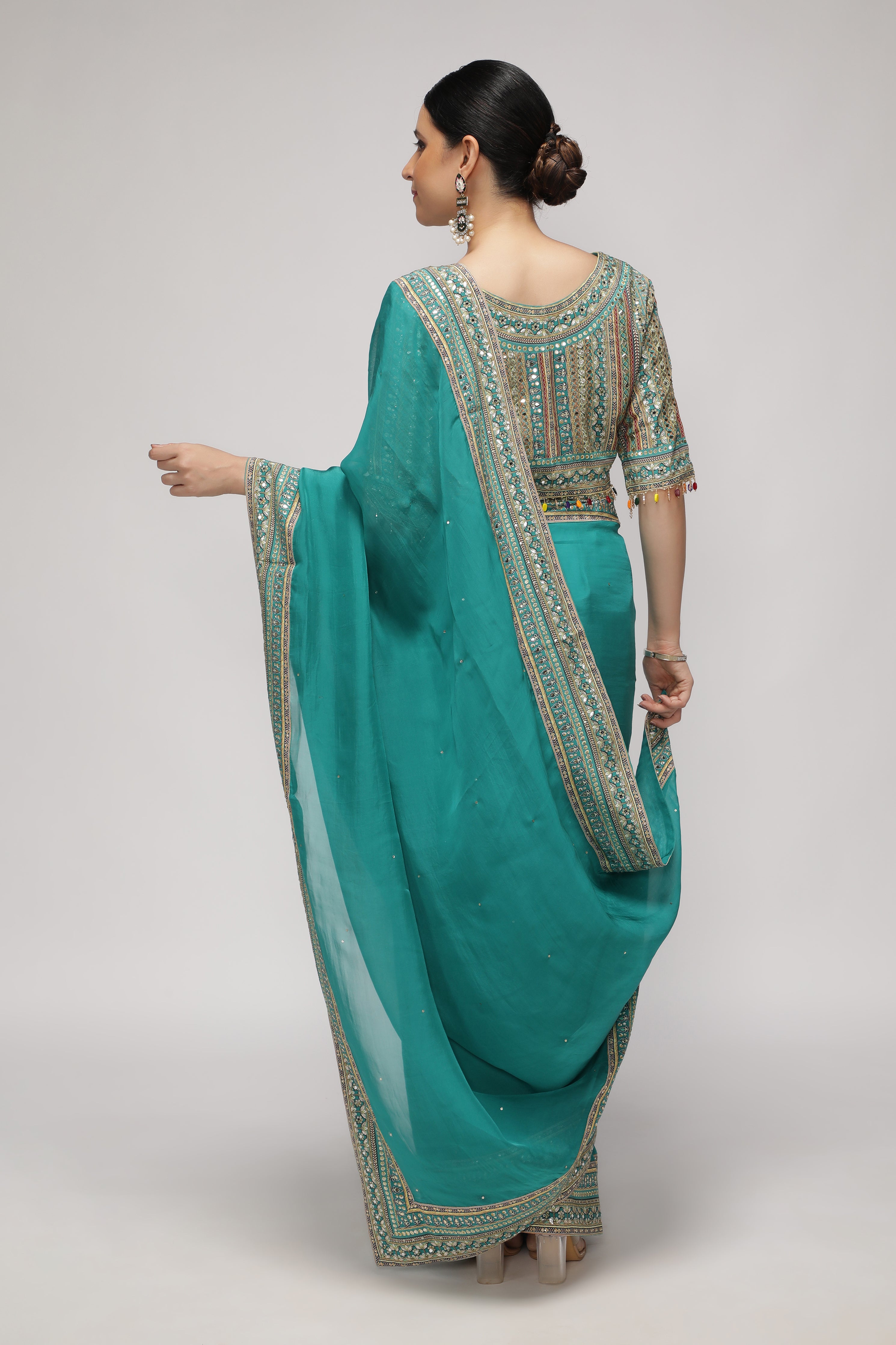 Teal Green Silk Organza Saree with Sequin Highlights & Mirror Work Border
