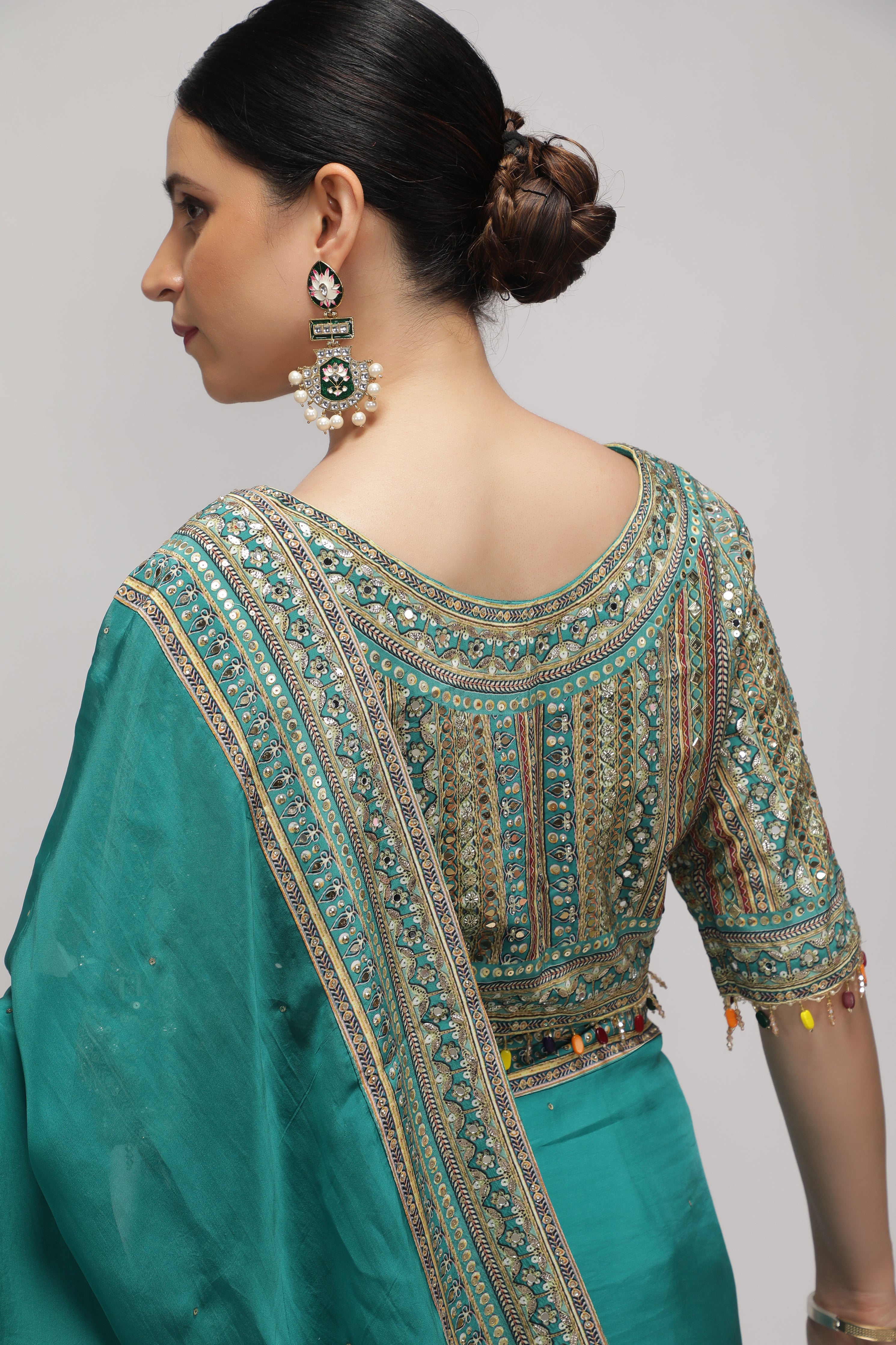 Teal Green Silk Organza Saree with Sequin Highlights & Mirror Work Border